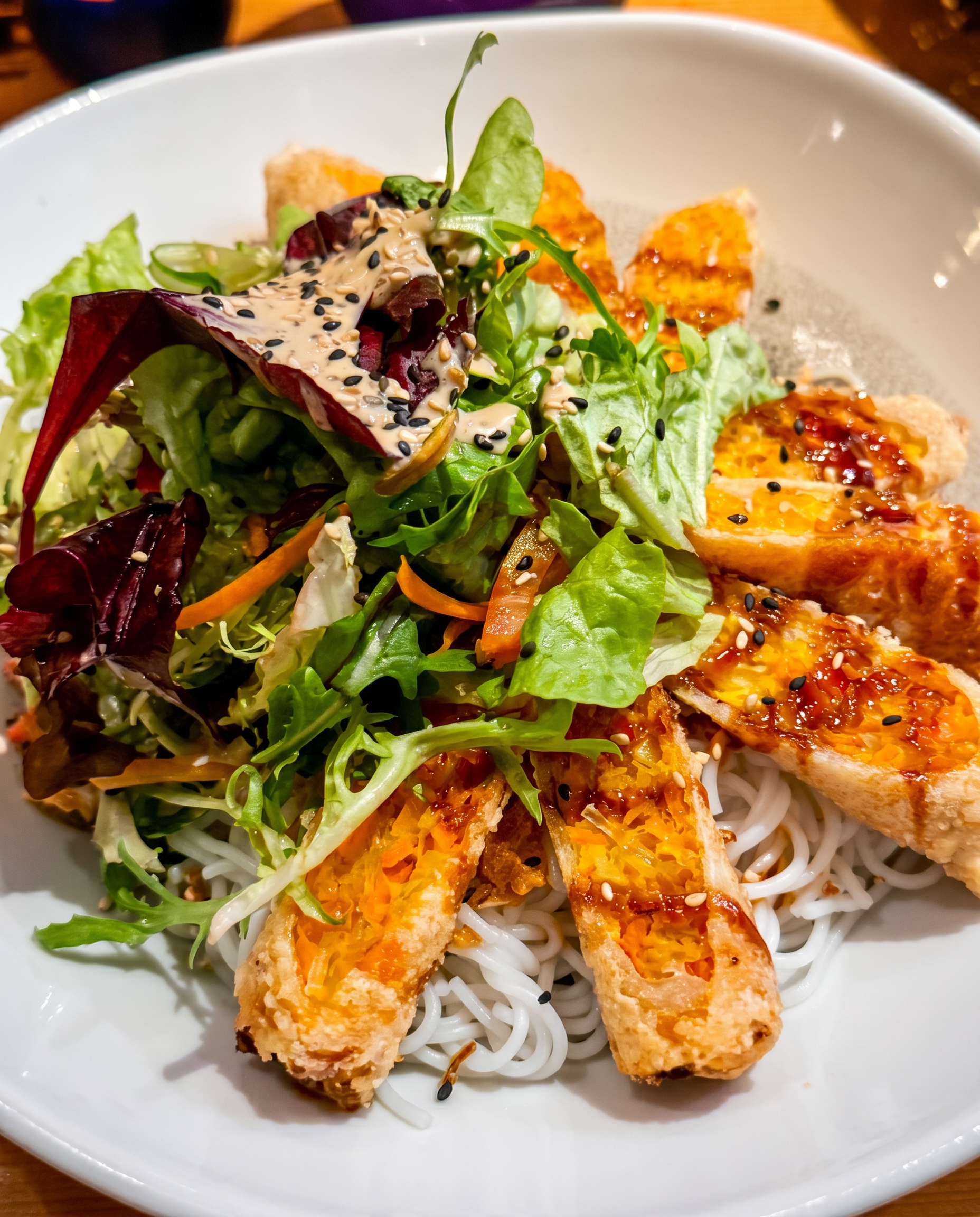 Crispy spring rolls on rice noodles