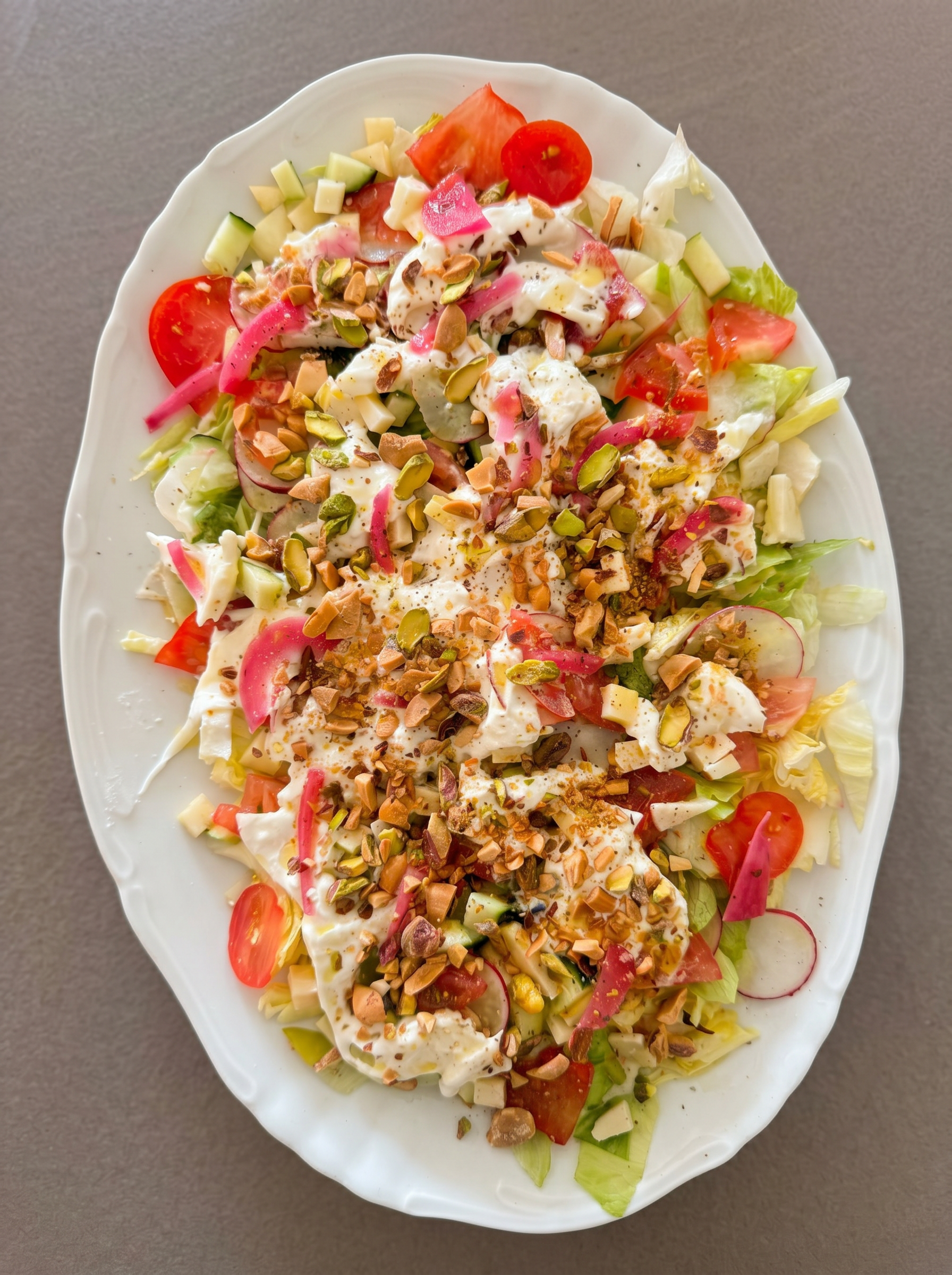 Crunchy salad with yogurt, pistachios and pickled onions