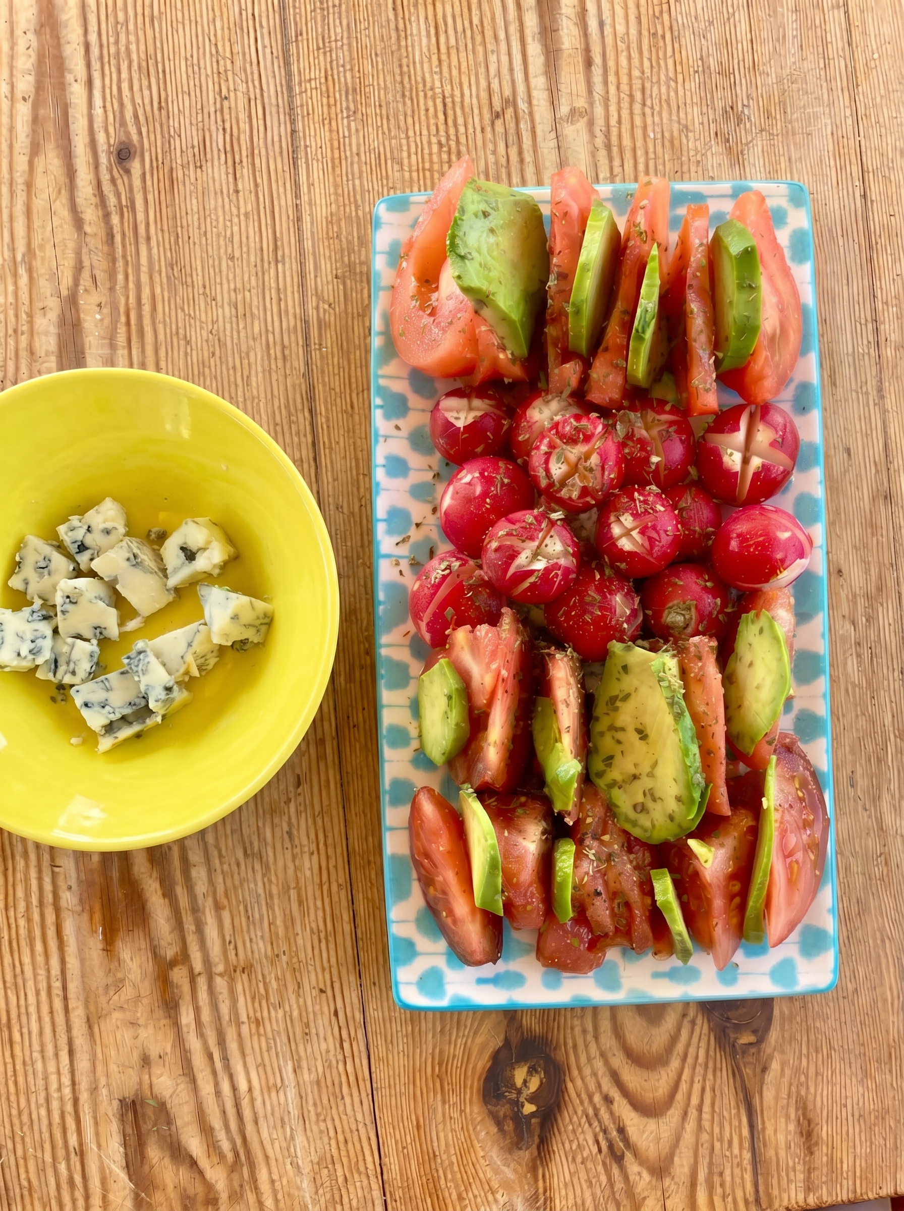 Tomato, avocado and radish plate with blue cheese