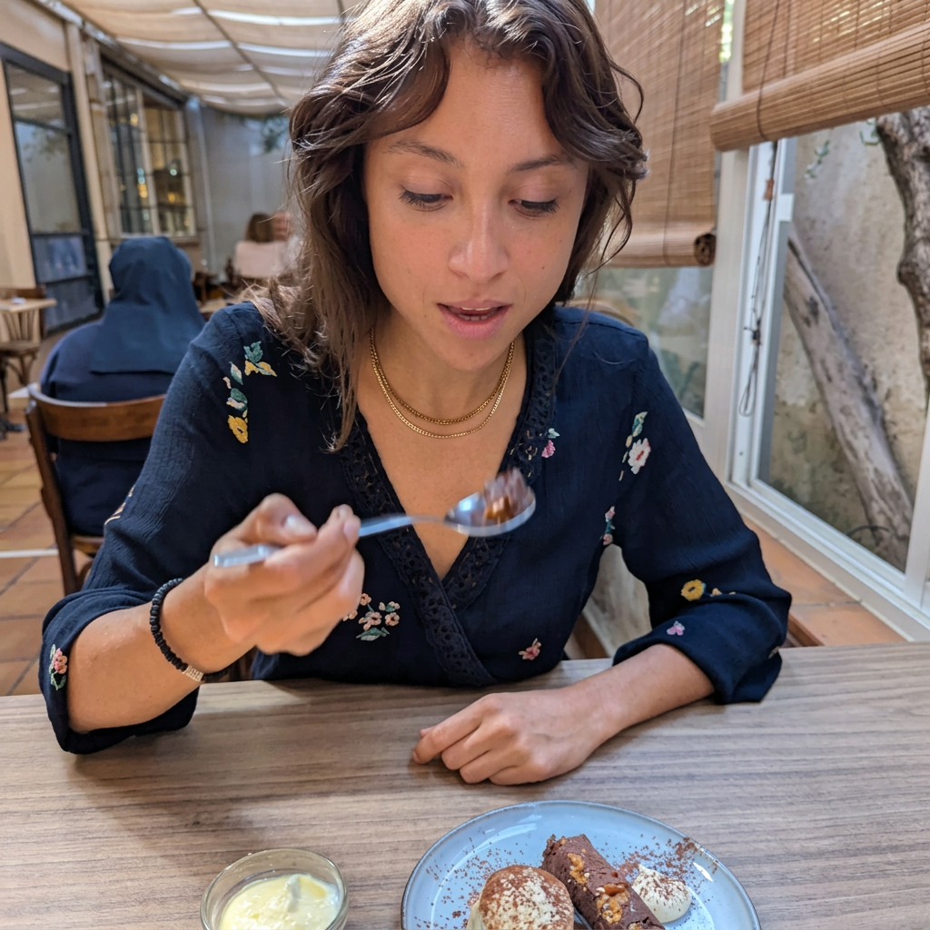 Lina enjoying a dish at the table